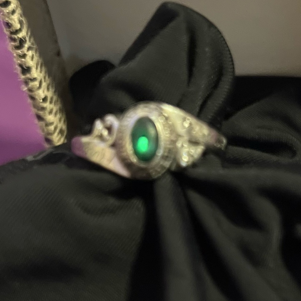 Elegant Silver Ring with Green Gemstone class engraving on it